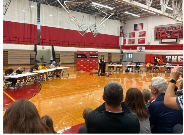 The Athletes signing their letters 