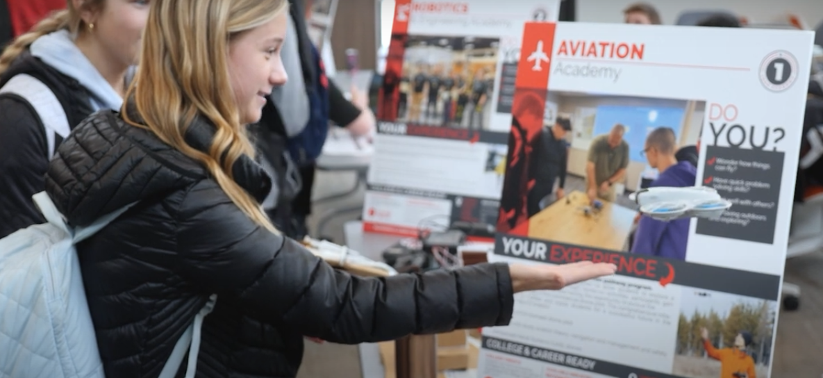 Students at the 2025 Career Academies Expo learning about the Aviation Academy.