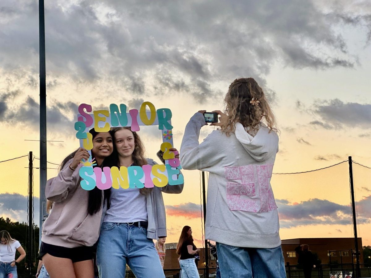 Taking pictures behind a custom 2026 Senior Sunrise frame