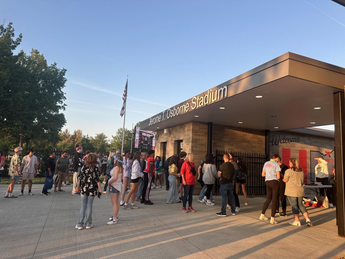 Entrance to Jerome T. Osborne Stadium, fans are lining up to buy tickets from the booth (back).