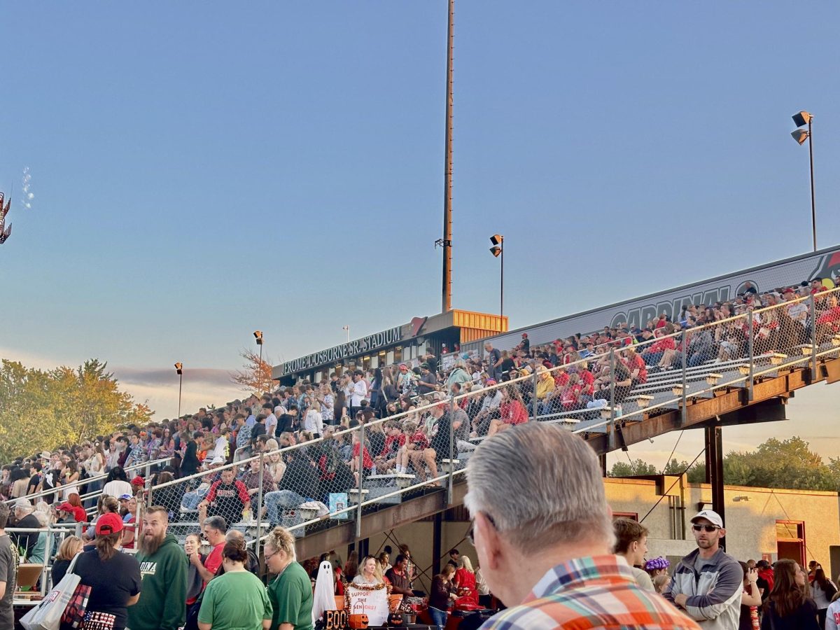 Mentor High School football fans sitting at the stadium chairs (7:02pm).