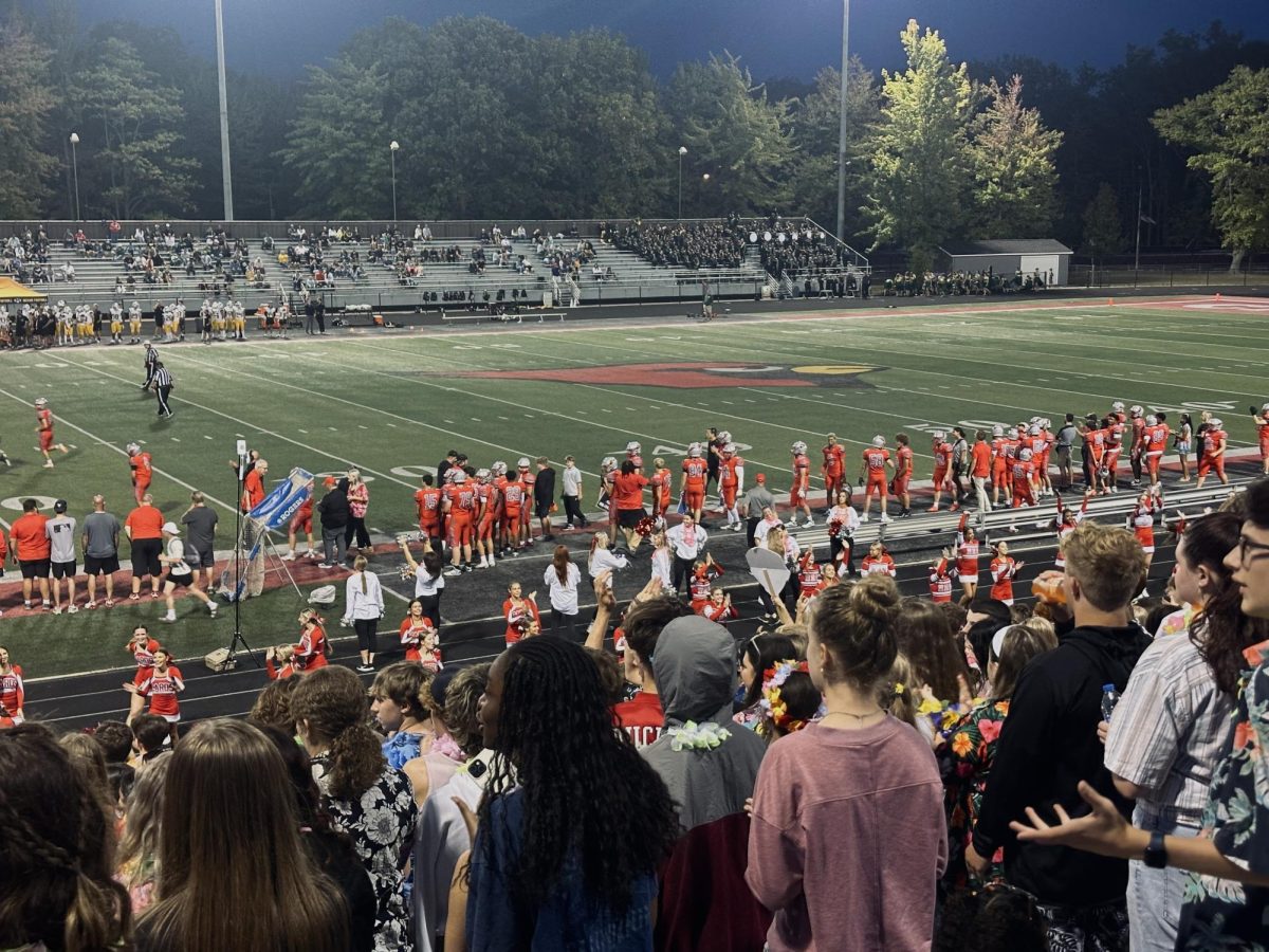 Mentor football players on the sideline.
