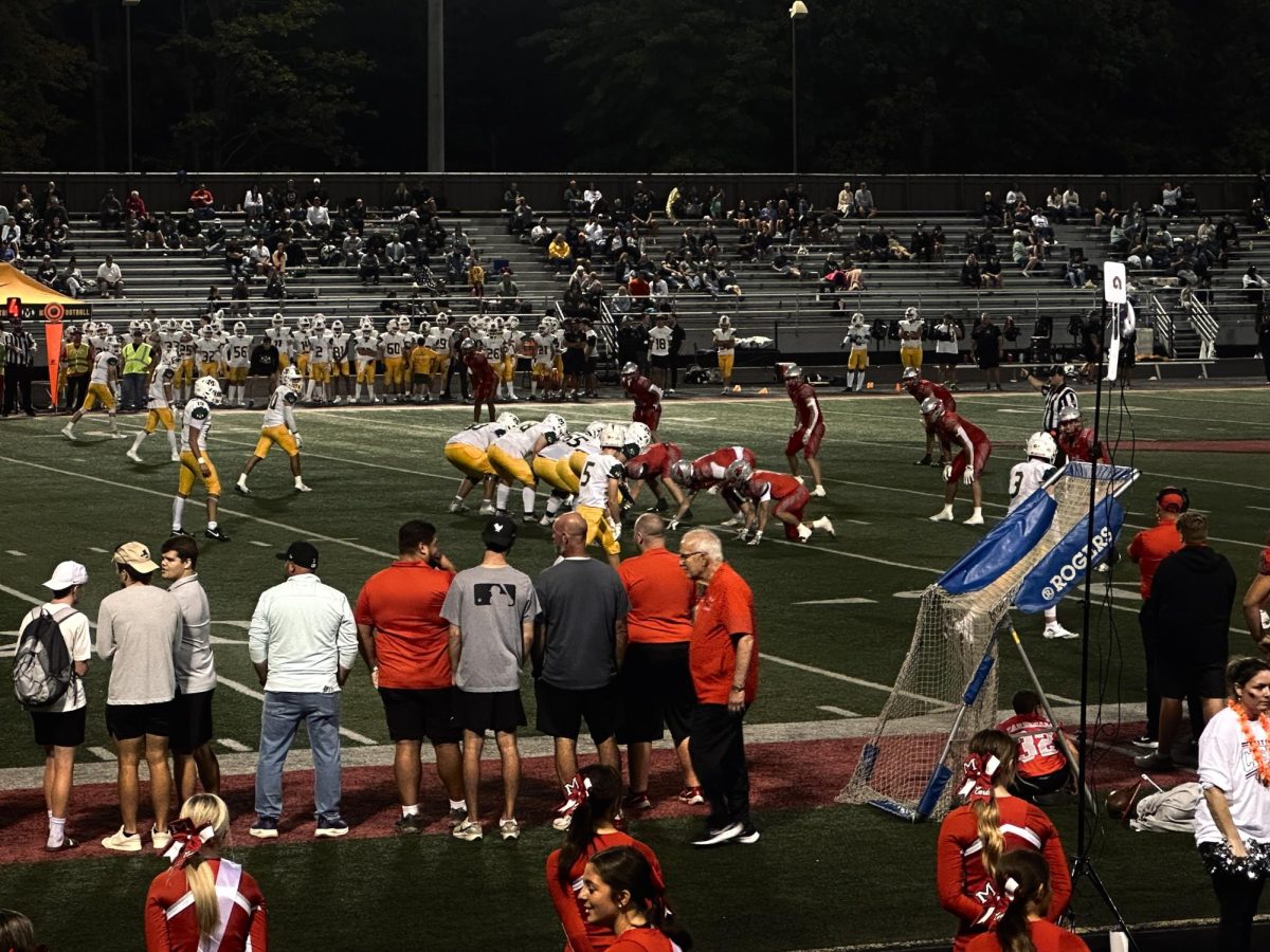Medina’s offense lined up against Mentor’s defense at the line of scrimmage, preparing for the snap.