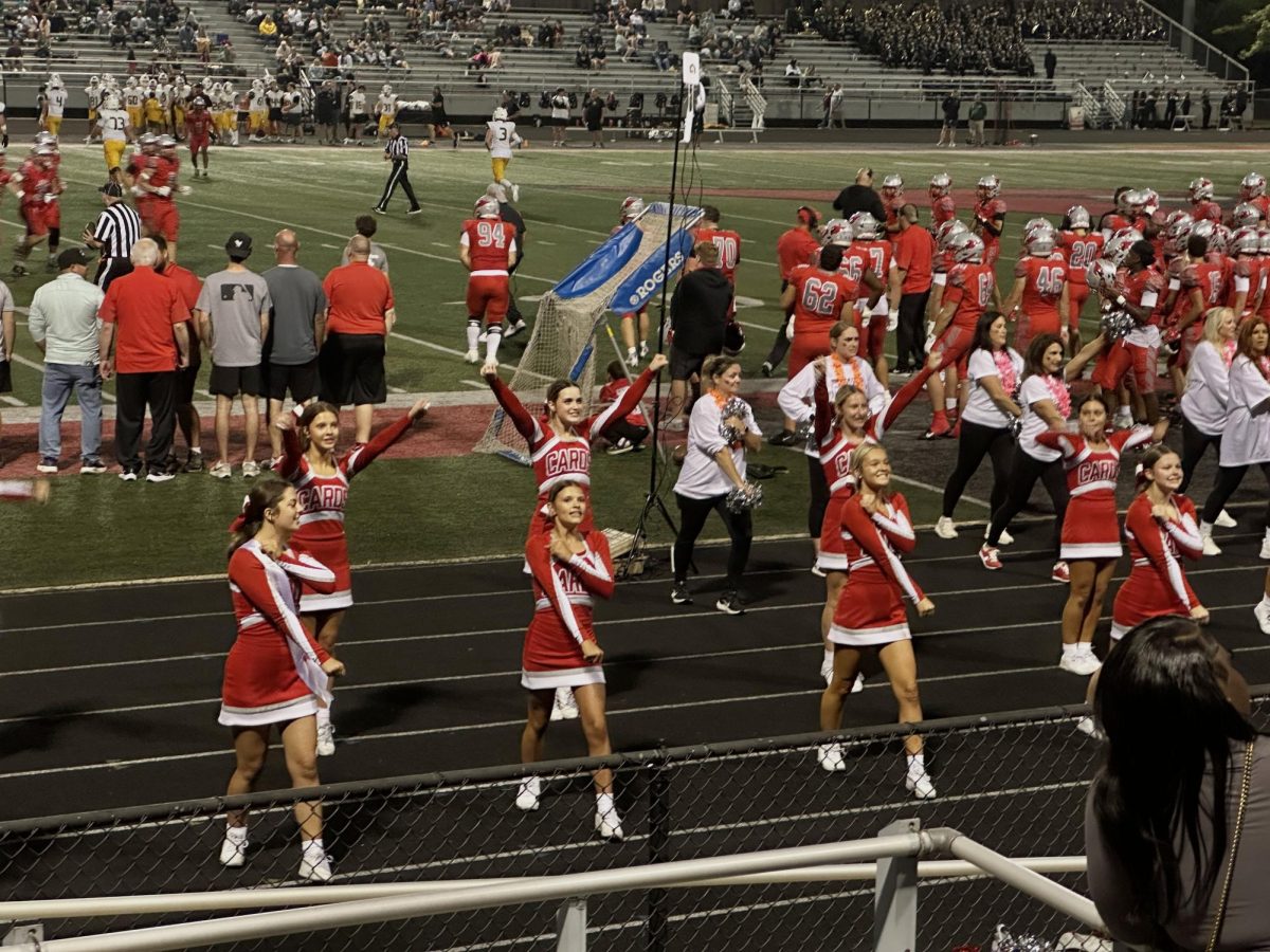 Mentor Varsity Cheerleaders cheerleading on the sidelines during quarter 2.
