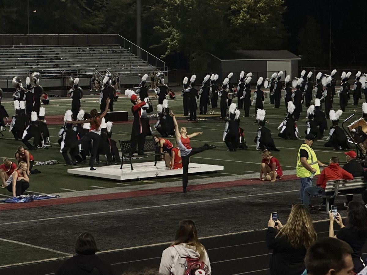 A majorette strikes a beautiful arabesque during halftime performance.