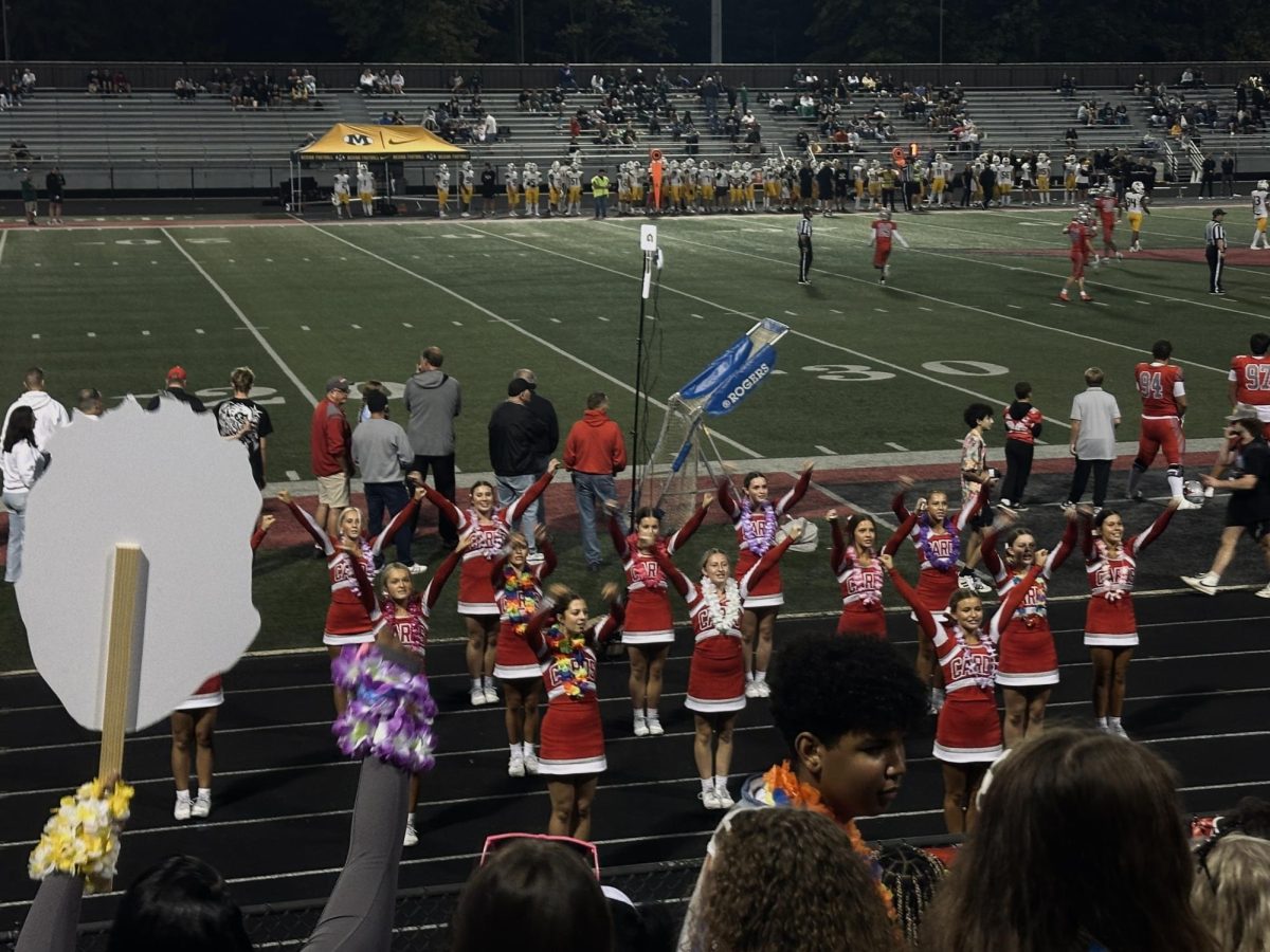 Mentor cheerleaders bringing energy to the field with their performance.