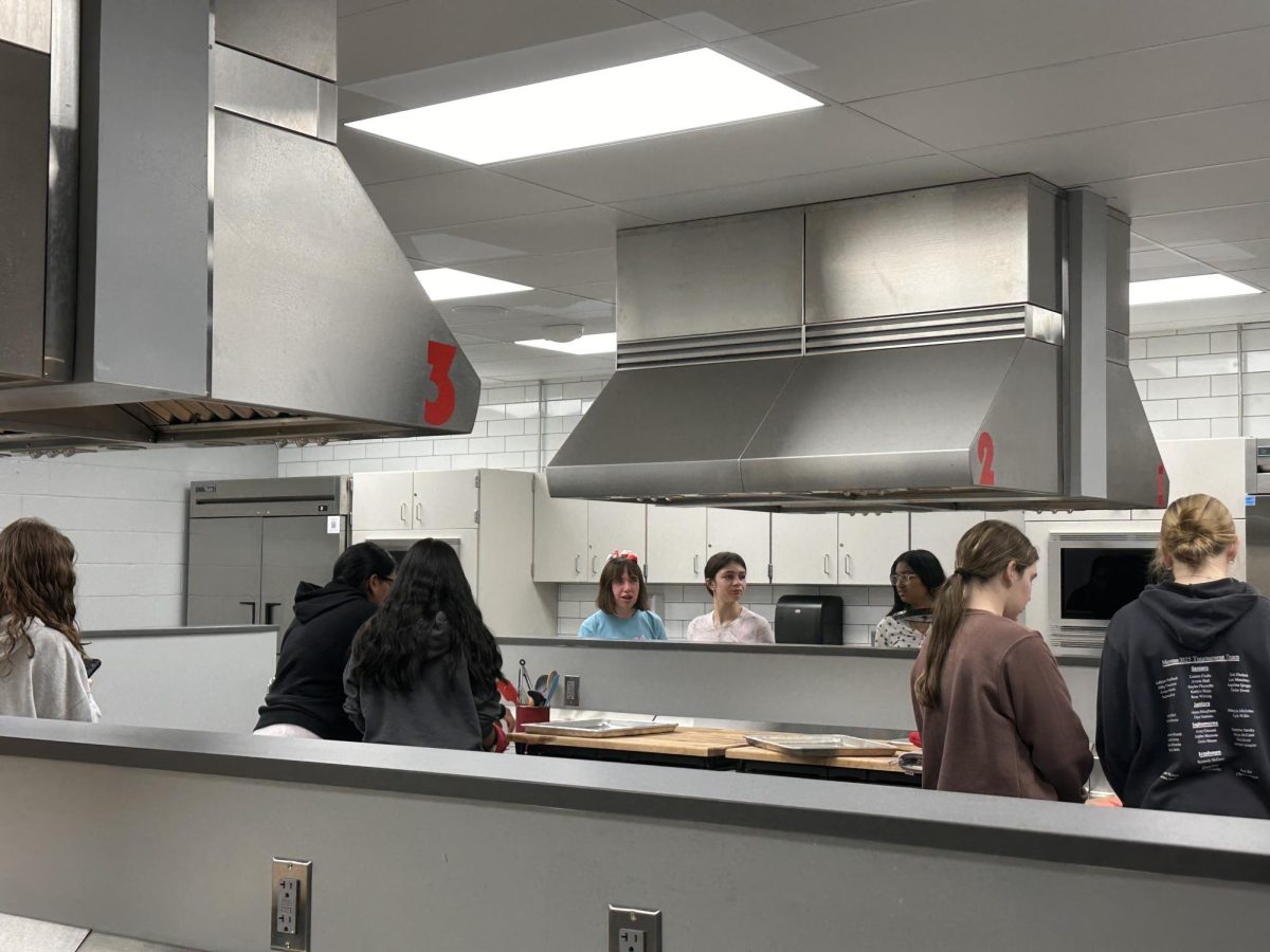 Future Leaders collaborating in small groups in the culinary kitchen. (Amelia Lee)