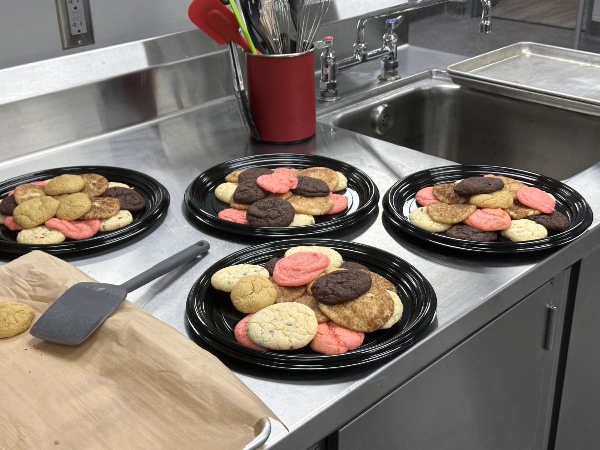 A variety of cookie flavors on each plate, baked by the Future Leaders members. Flavors include birthday cake, chocolate, strawberry, snickerdoodle, and vanilla. (Amelia Lee)