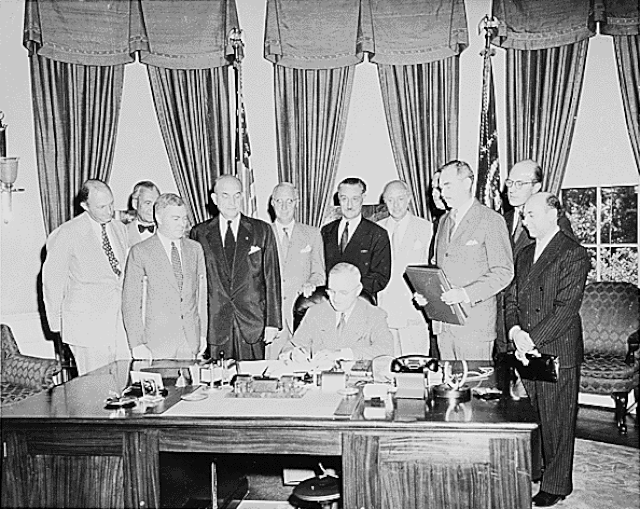 U.S. President Harry Truman signs the bill ratifying the North Atlantic Treaty, part of creating the North Atlantic Treaty Organization (NATO)